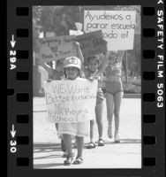 Four girls carrying signs, one reading "We Want Better Education NO Year Round School" in Los Angeles, Calif., 1981