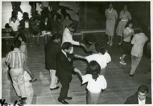 Group of teenage boys and girls dancing