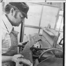 Henry Holberg sharpens a hand saw in his shop. (He and his son Henry Jr. still had a shop, Nobile Saw Works, at 3011 J Street, in 2015.)
