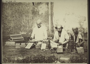A parsi and two hindus making little boxes from sandel wood inlaid with ivory