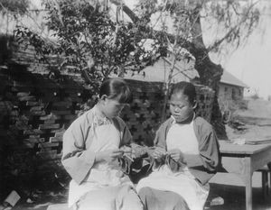 Blind Home in Mukden. Two blind girls knit. Applied 1933