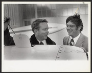 Two men chatting while maintaining a plane