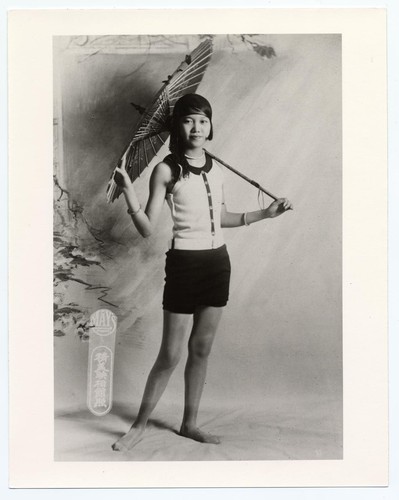 Tam Yuk-lan, the Great Star's first bathing beauty standing with parasol /