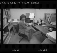 Librarian Vivian Arterbery working at terminal of Rand Corp. library's barcode based computer system, 1980