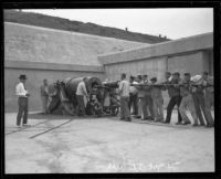 Members of the first civilian coast artillery crew load a mortar battery gun at Fort MacArthur, San Pedro, 1921