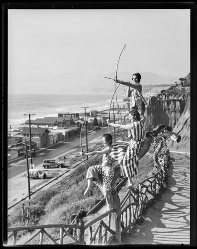 Models posing as archers on the road to Palisades Park, Santa Monica
