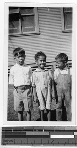 Three boys standing outside in front of a house, Honolulu, Hawaii, ca. 1928