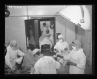 Student nurses and interns in an operating room, Queen of Angels Hospital, Los Angeles, 1956