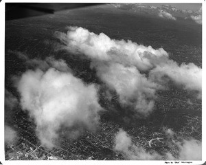Aerial view of downtown Los Angeles over Bunker Hill looking north through the clouds towards Hollywood