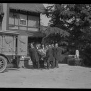 Pallbearers carry the coffin of Arthur Letts toward a funeral wagon at ...