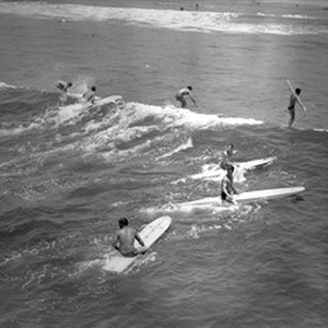 Surfers riding waves at a Los Angeles County Beach, 1950-1960