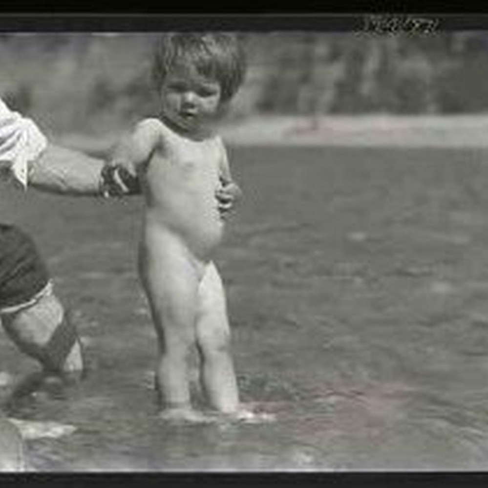 Naked child Naked baby standing in shallow water — Calisphere