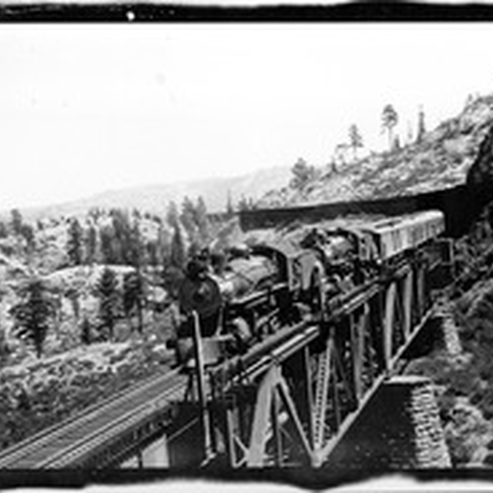 Southern Pacific Railroad train coming out of snow sheds in
